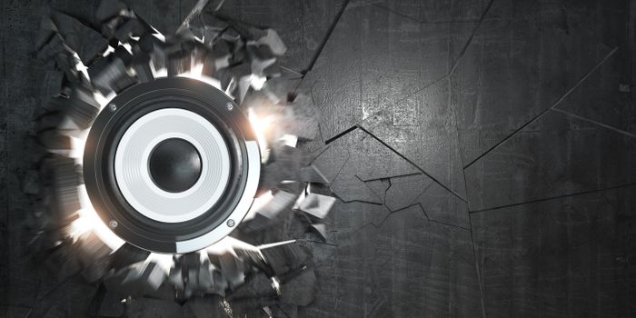 A speaker burts through a black wall, shattering the space where it appeared and cracking the rest of the surface.